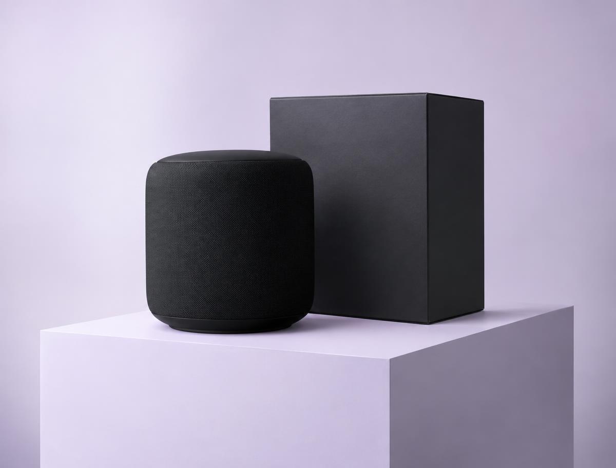 Black speaker and box on a lilac pedestal